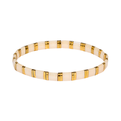 Gold and beige bracelet on a white background