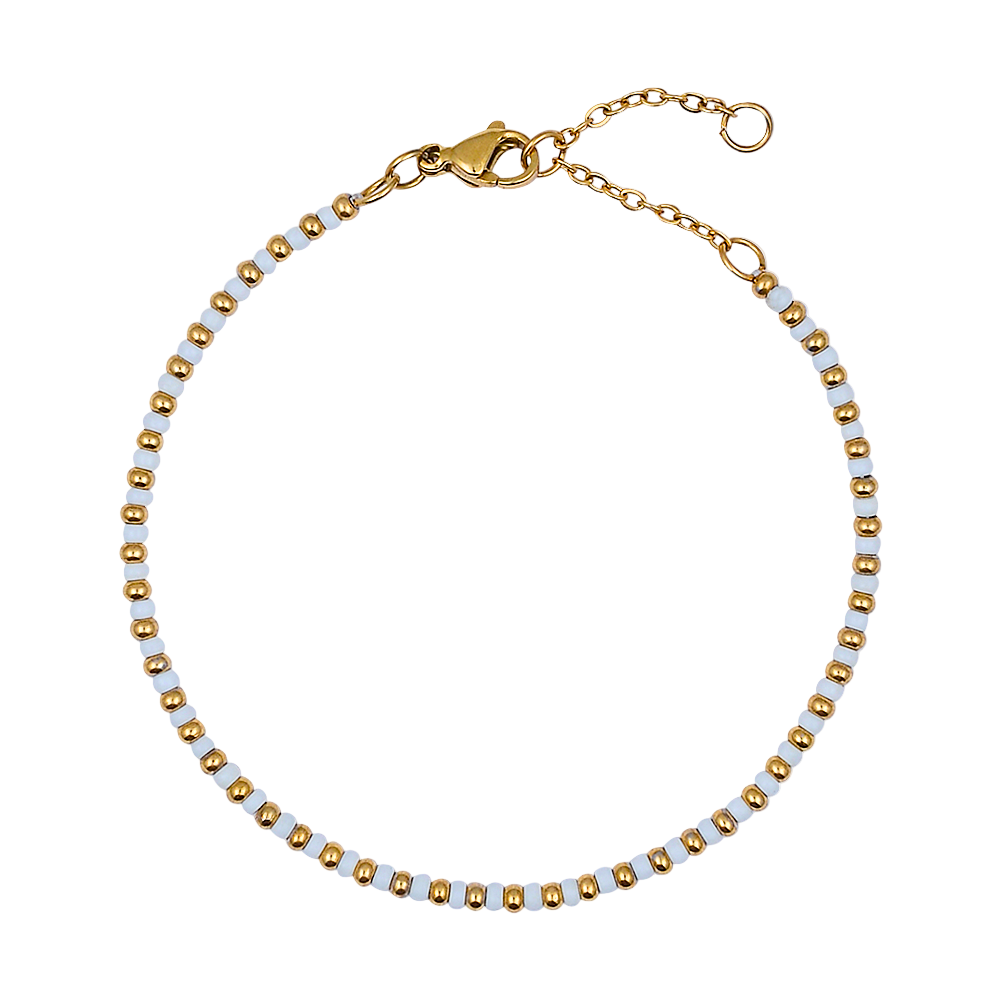 Bracelet with gold and white beads on a white background