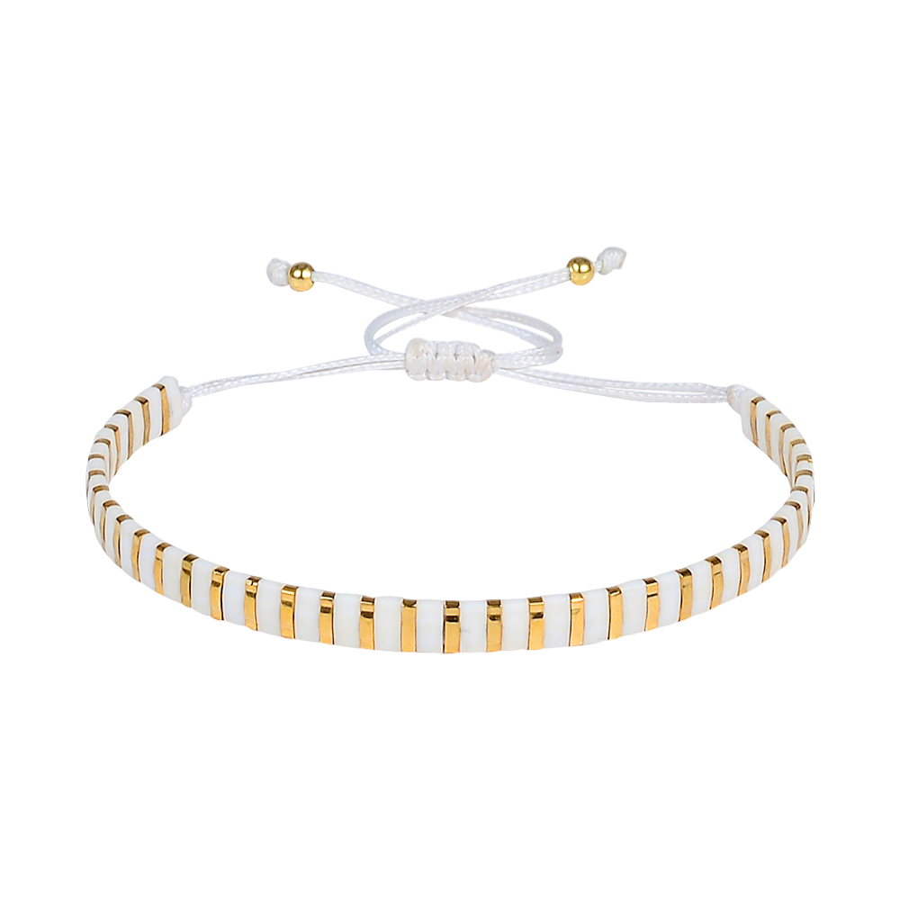 White and gold beaded bracelet on a white background