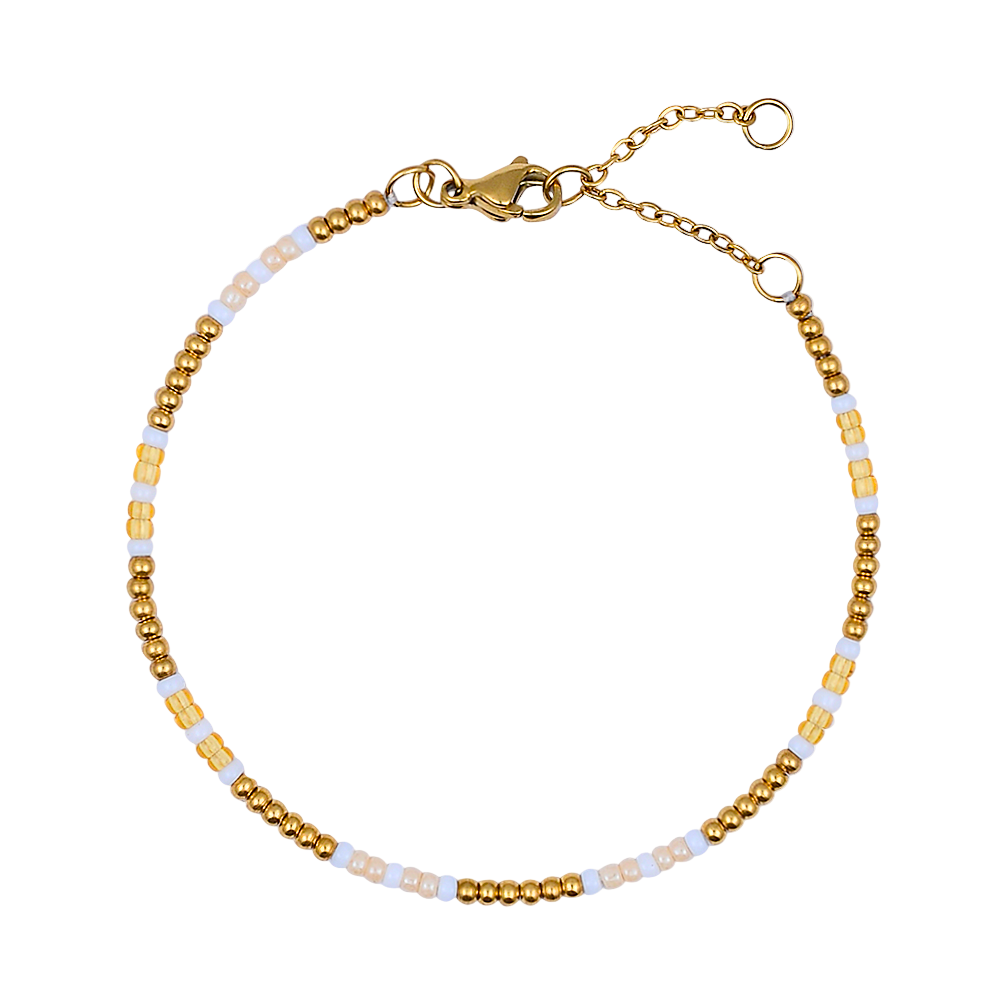 Gold and white beaded bracelet on a white background