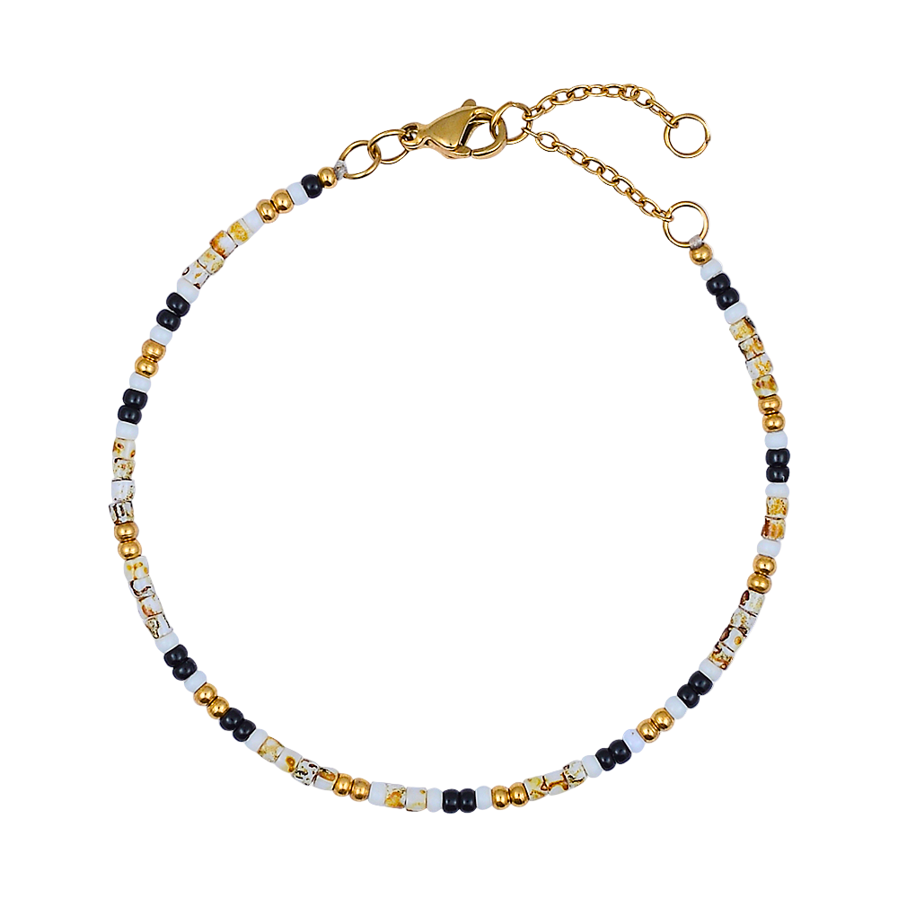 Beaded bracelet with gold, black, and white beads on a white background